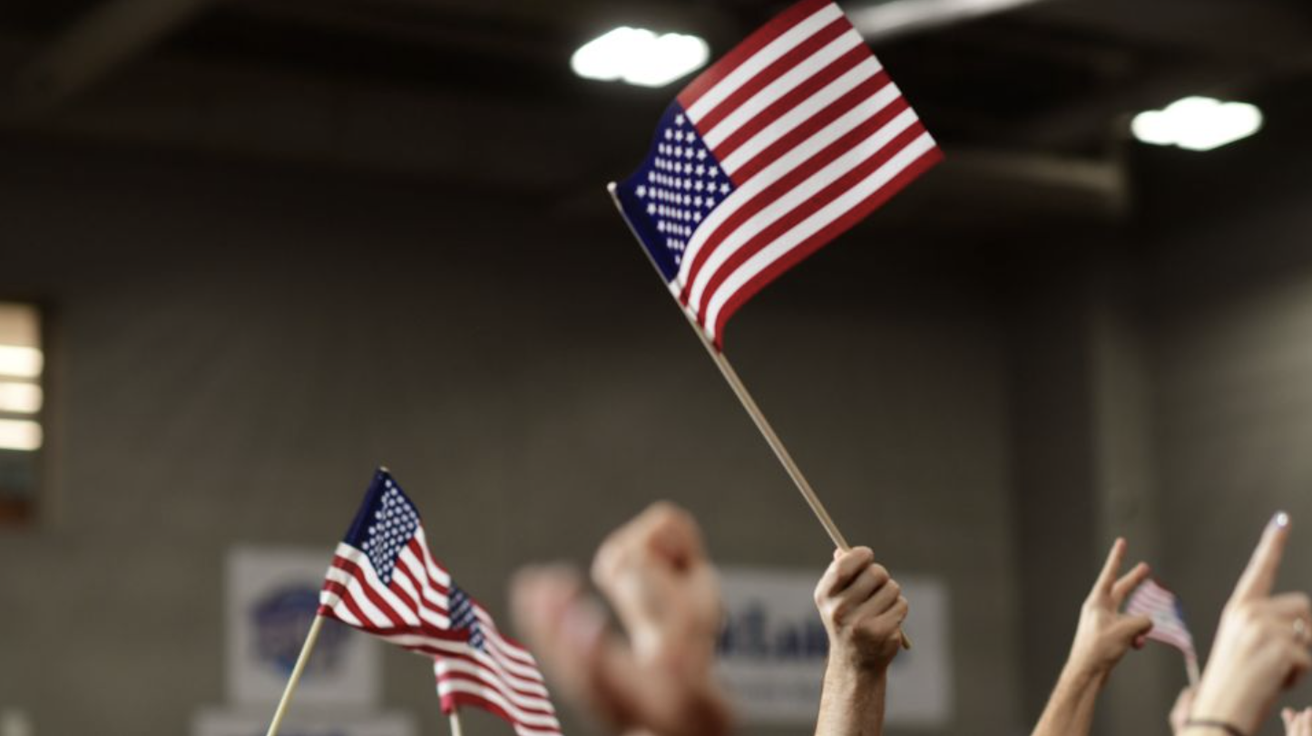 Supporters wave American flags before Democratic Pennsylvania Senate nominee John Fetterman holds a rally on September 11, 2022, at Montgomery County Community College in Blue Bell, Pennsylvania.