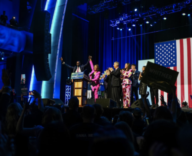 Gov. Gretchen Whitmer and Lt. Gov. Garlin Gilchrist raise their hands together at the end of Whitmer's celebratory speech during an election night watch party Nov. 8 in Detroit. (Nick Hagen/For The Washington Post)