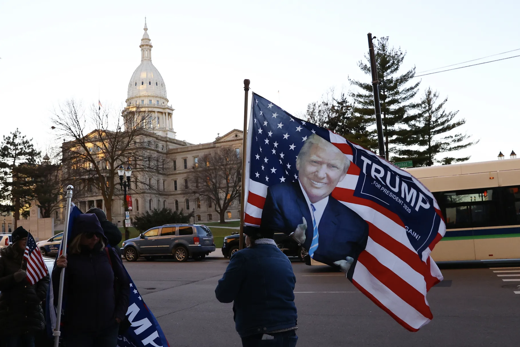 Supporters of former President Donald Trump gather outside the Michigan House building before Trump’s personal attorney Rudy Giuliani testified on December 2, 2020, in Lansing, Michigan. Rey Del Rio/Getty Images